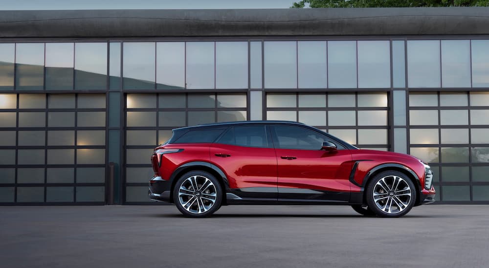 A red 2024 Chevy Blazer EV SS is shown parked outside a garage.