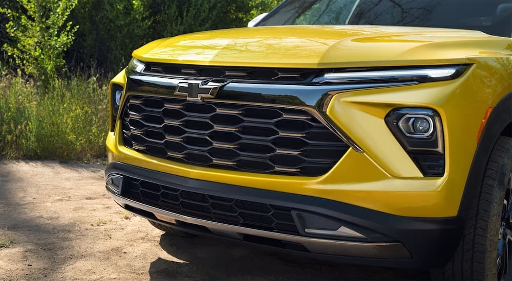 A close-up of the grille on a yellow 2024 Chevy Trailblazer ACTIV is shown.