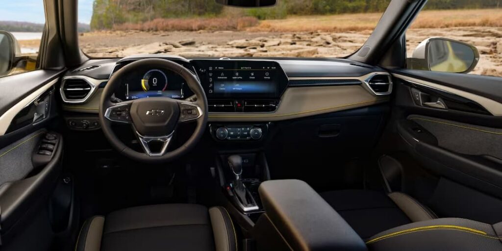 The gray and yellow interior and dash of a 2024 Chevy Trailblazer is shown.