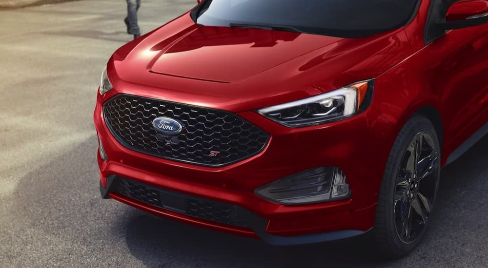 A close-up of the front end on a red 2024 Ford Edge ST is shown.