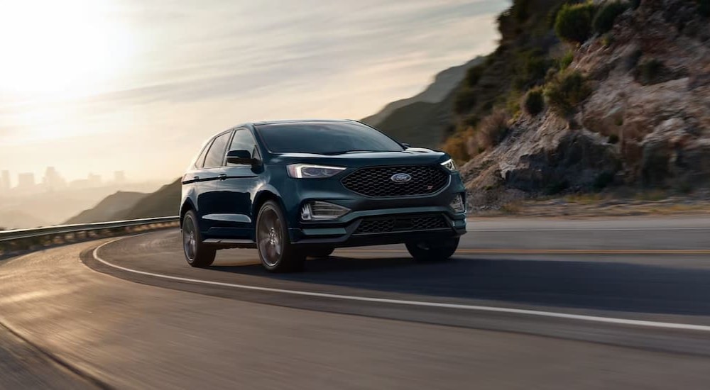 A green 2024 Ford Edge is shown driving on a highway.