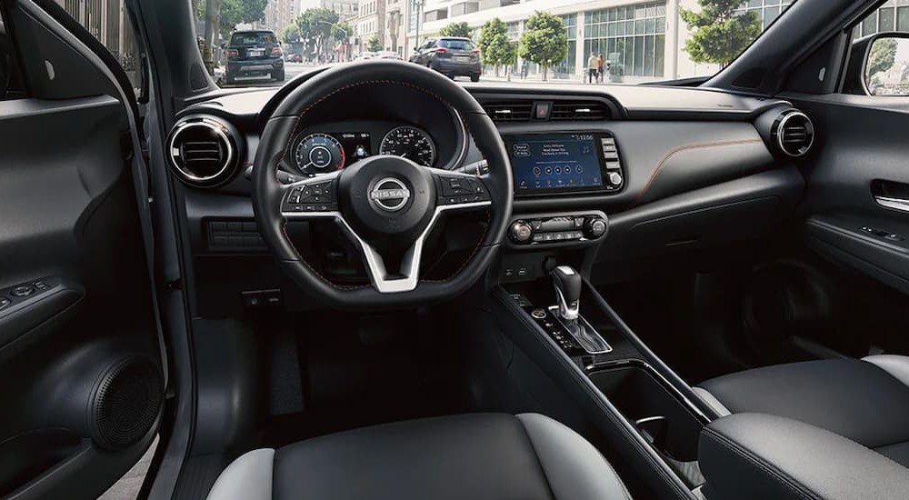 The black interior and dash of a 2024 Nissan Kicks is shown.