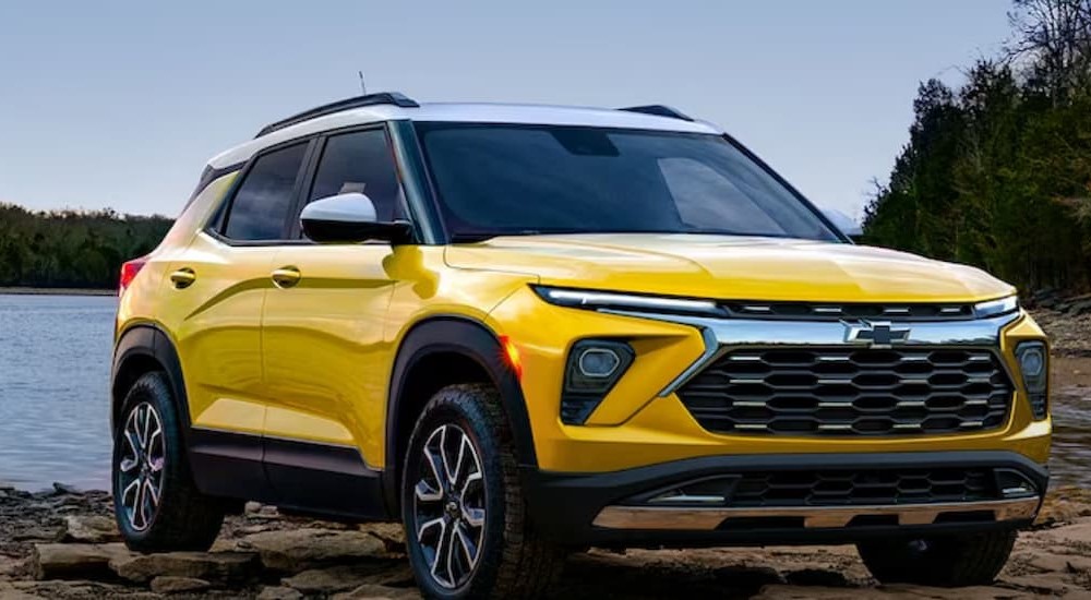 A yellow Chevy Trailblazer is shown parked near a lake.