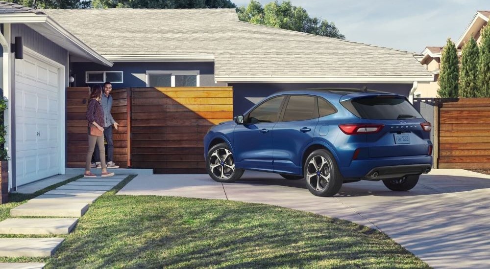 A blue 2023 Ford Escape is shown parked on a driveway.