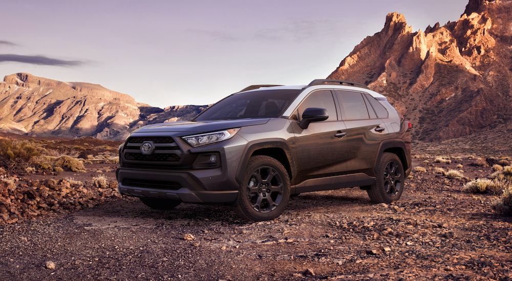 A grey 2021 Toyota RAV4 is shown parked off-road.
