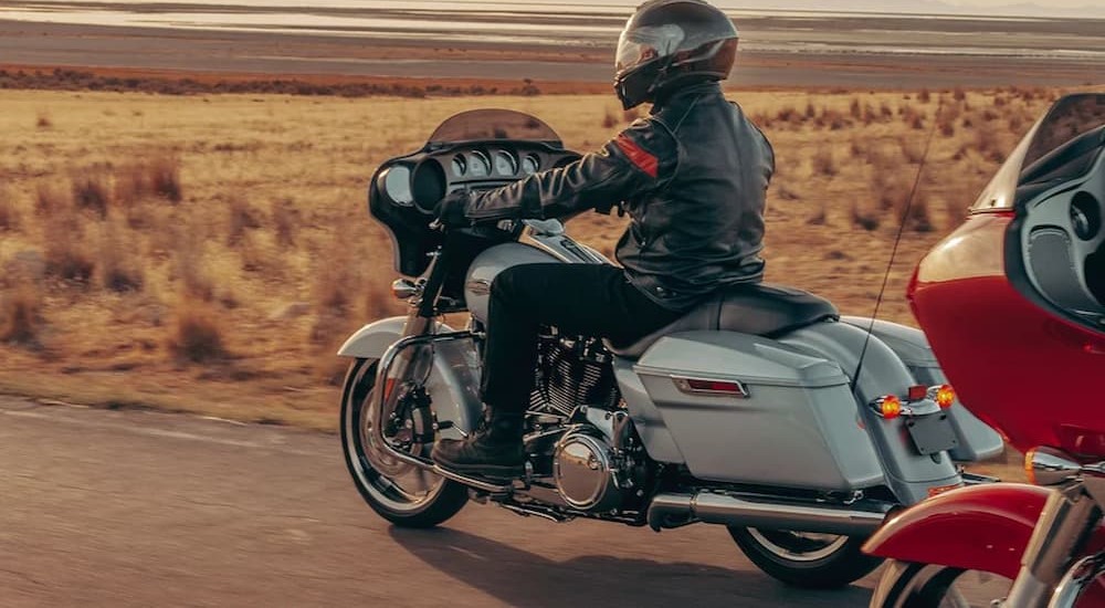 A person is shown riding a white 2023 Harley-Davidson Street Glide ST.