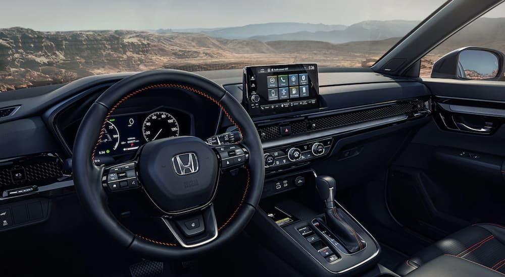 The black interior of a 2023 Honda CR-V Sport Touring is shown.