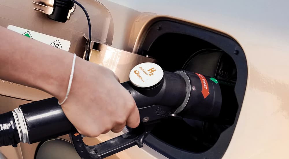 Close-up of a hydrogen refueling pump connected to a 2024 Hyundai Nexo. 