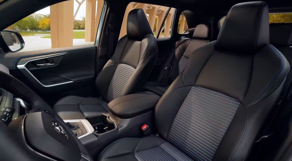The black interior of a 2023 Toyota RAV4 is shown.