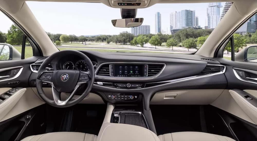 The black and white interior and dash of a 2024 Buick Enclave Avenir is shown.