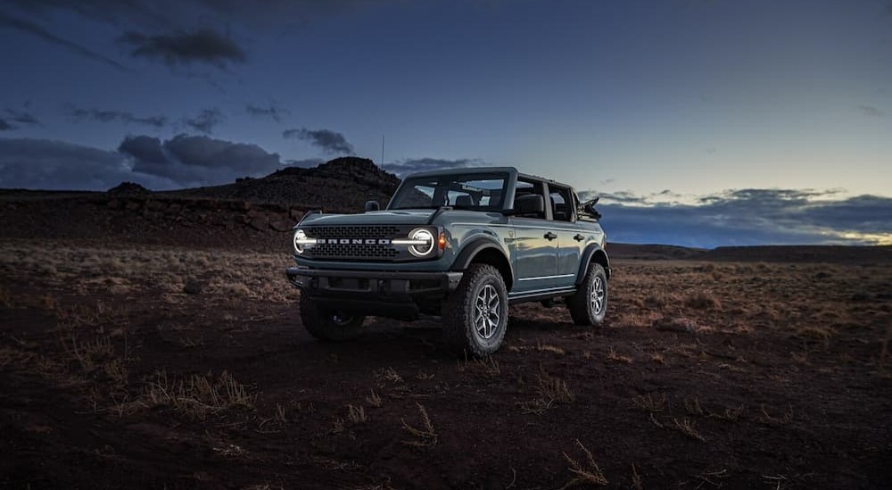 A blue 2024 Ford Bronco Sport Badlands is shown parked off-road after visiting a Ford Bronco Sport dealer.