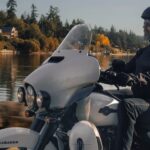 A white 2024 Harley-Davidson Ultra Limited for sale is shown riding by a lake.
