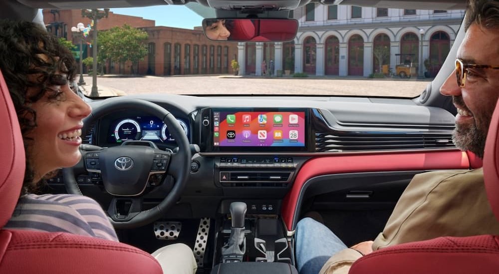 The black and red interior and dash of a 2025 Toyota Camry is shown.