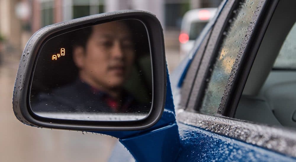 A man is shown looking into a mirror while it flashes a safety warning.