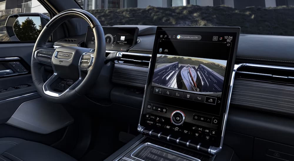 The interior of a 2024 GMC Sierra EV Denali with large infotainment screen.