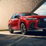 A red 2024 Lexus NX for sale parked in a modern garage.