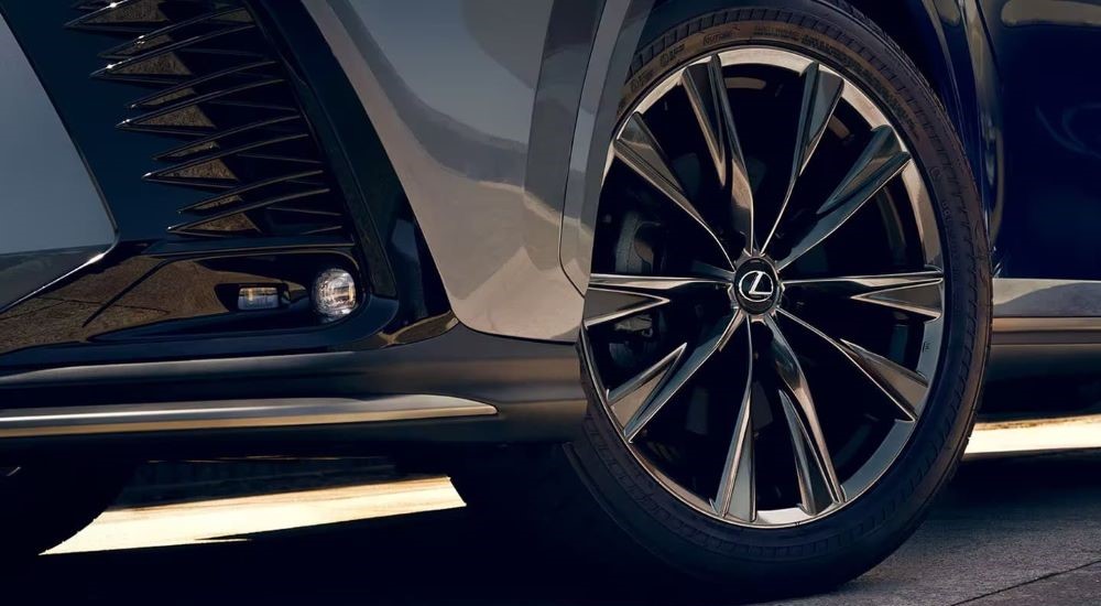 A close up of the front wheel of a grey 2024 Lexus NX. 