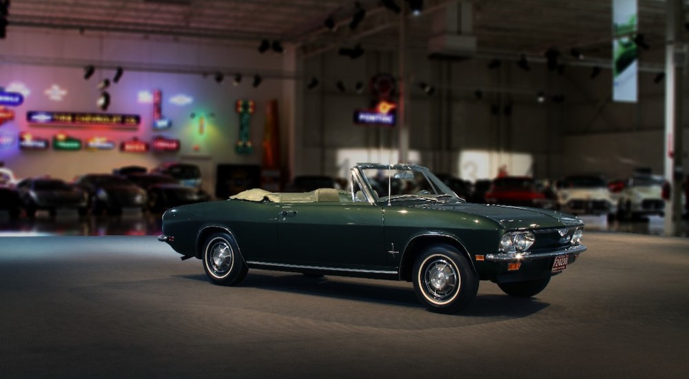 A green 1969 Chevrolet Corvair is shown parked in a garage.