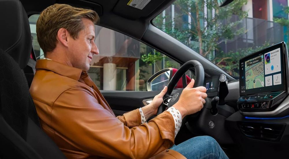 A person is shown driving in the interior of a 2023 Volkswagen ID.4 Pro after visiting a Volkswagen dealer.