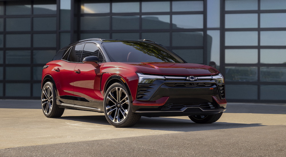 A red 2024 Chevy Blazer EV RS is shown parked outside a building.