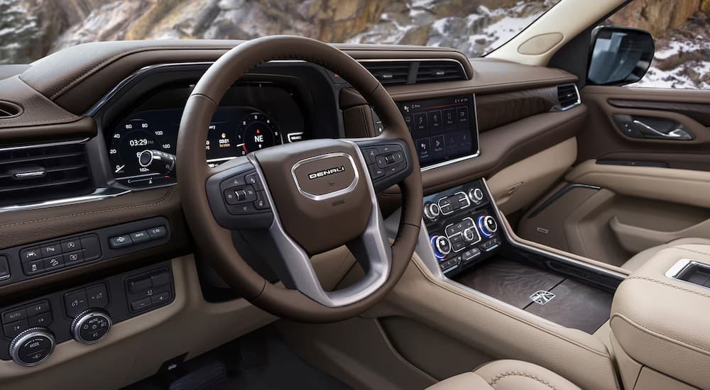 The brown and tan interior of a 2024 GMC Yukon Denali.