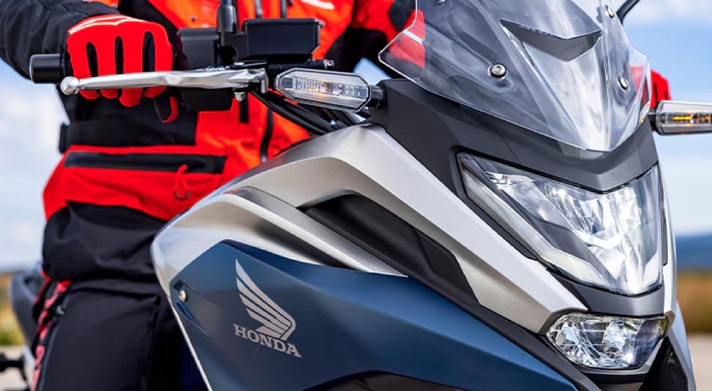 Close-up of the Honda logo on a blue 2024 Honda NC750X DCT.