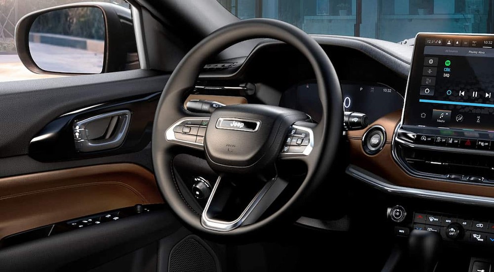 The black and brown dash is shown in a 2024 Jeep Compass.