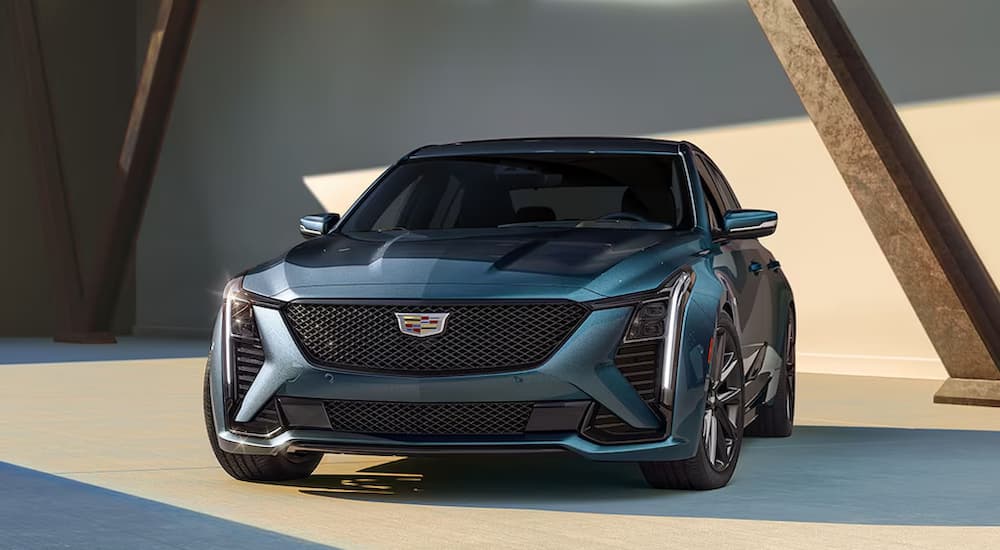 A blue 2025 Cadillac CT5 parked in the sunlight.