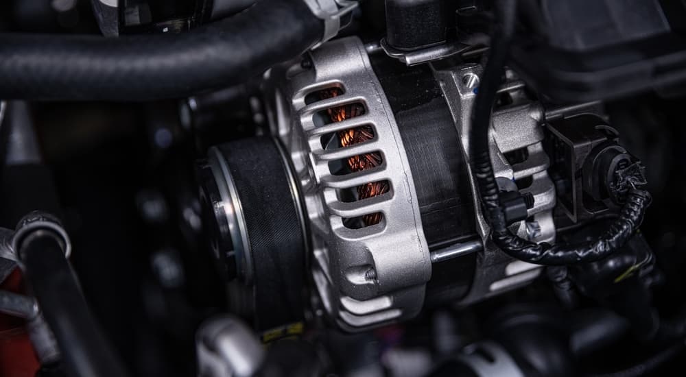 An alternator is shown inside a car.