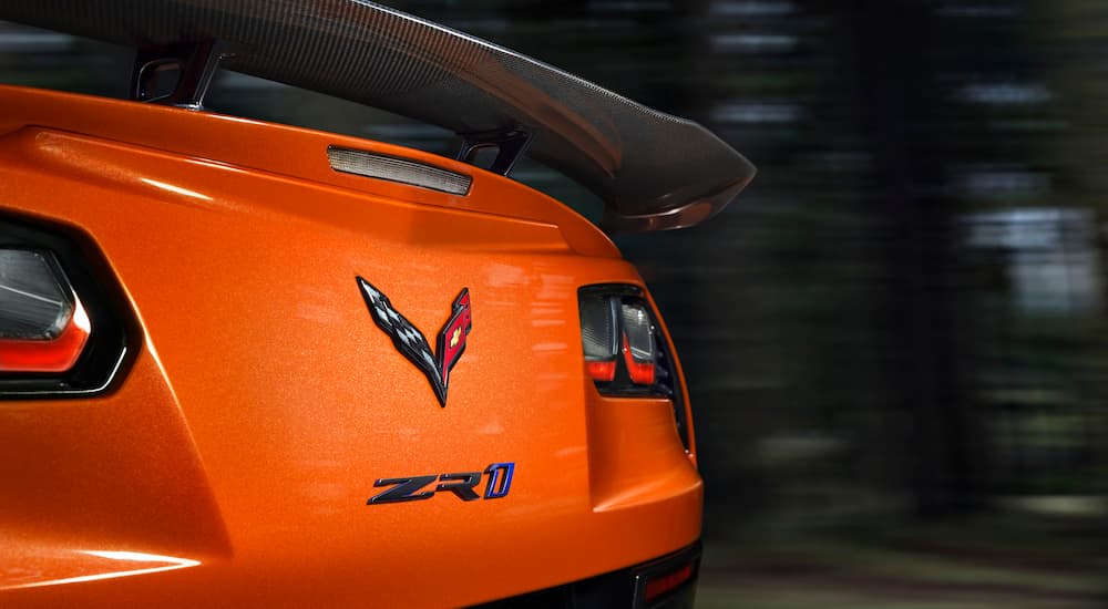 Close-up of the spoiler and badging on the back of an orange 2019 Chevy Corvette ZR1.