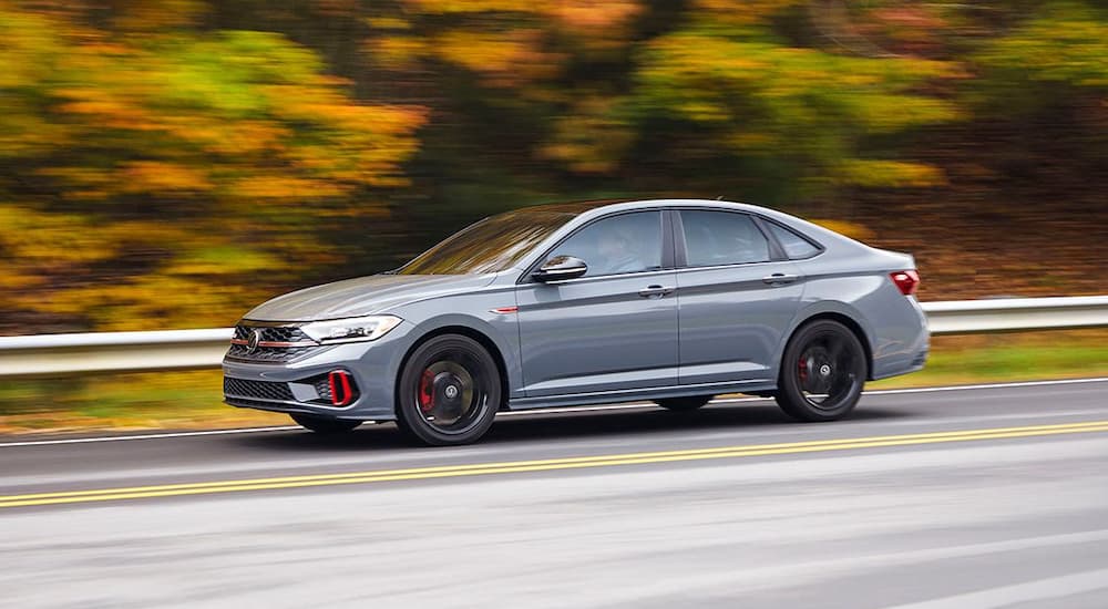 A silver 2022 Volkswagen Jetta GLI is shown driving.