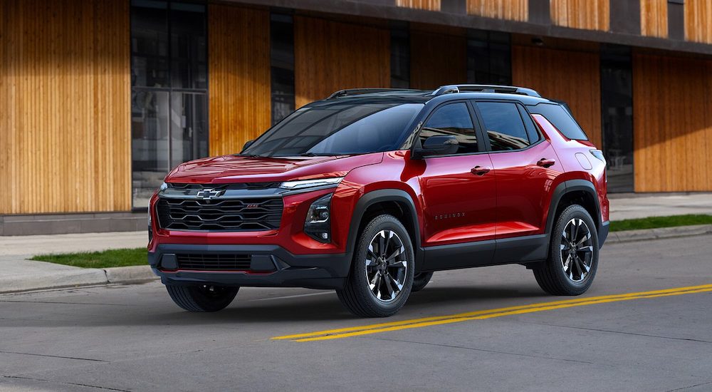 A red 2025 Chevy Equinox is shown driving from a Chevy dealer.