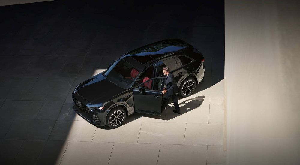 A black 2025 Mazda CX-70 is shown from a high angle after visiting a Mazda dealer.