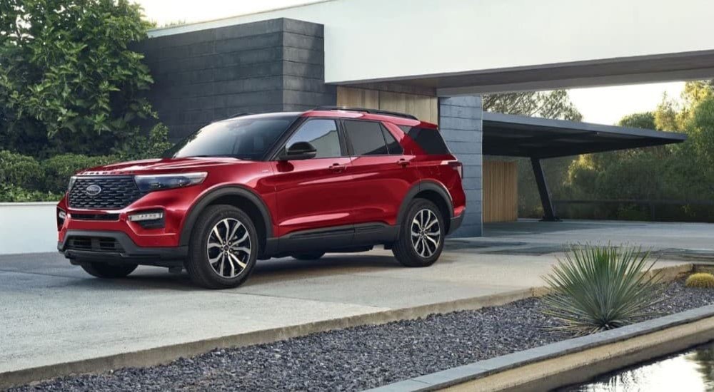 A red 2024 Ford Explorer ST-Line is shown parked on a driveway.