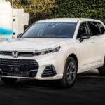 A white 2025 Honda CR-V e:FCEV parked on a curb.