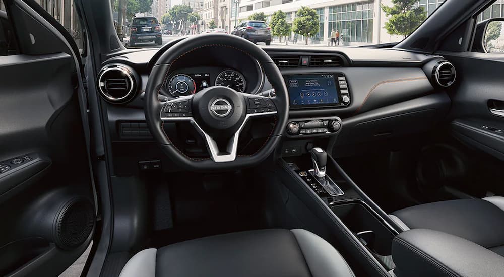 The black interior of a 2024 Nissan Kicks SR for sale.