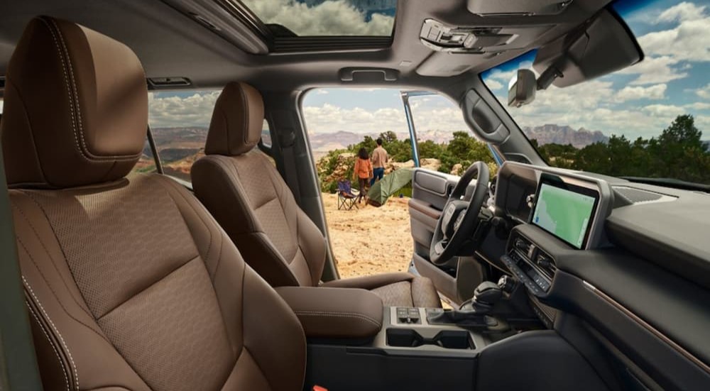 The black and brown interior and dash is shown in a 2024 Toyota Land Cruiser.