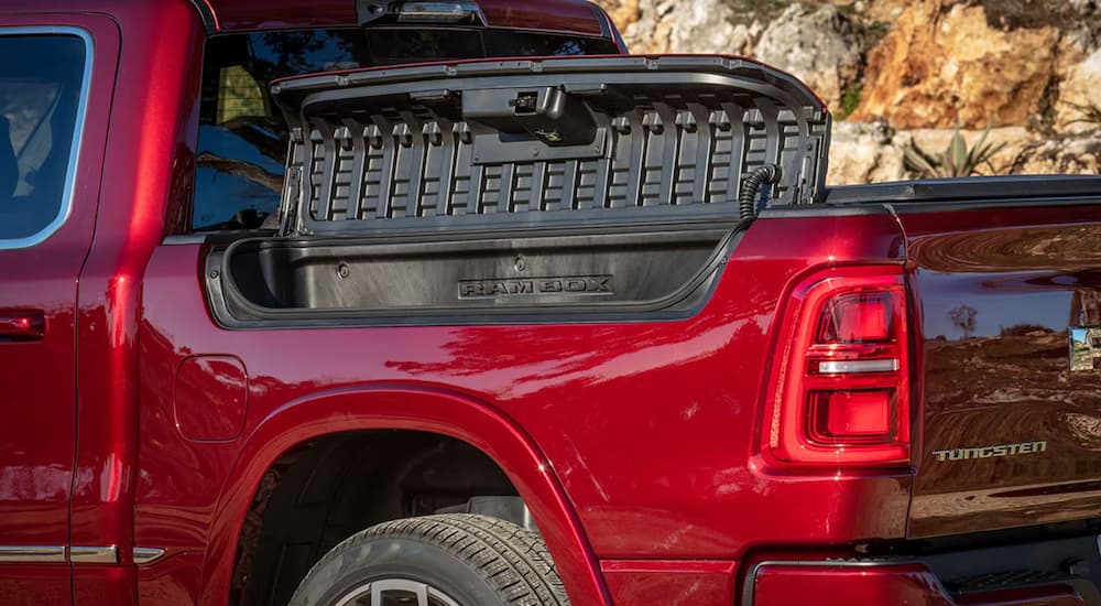 A close up of the RamBox on a red 2025 Ram 1500 Tungsten.