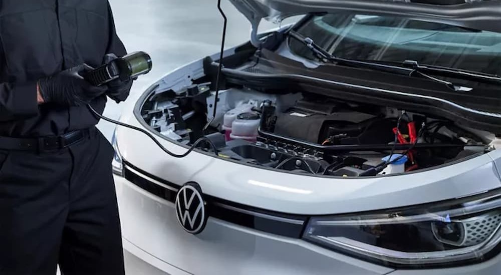 A technician is shown holding an engine reader.