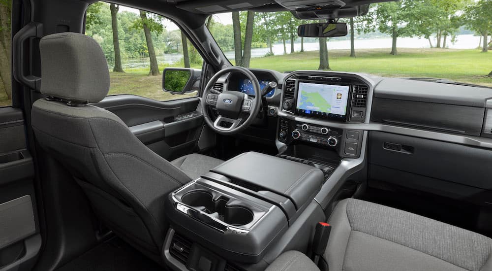 The interior of a 2024 Ford F-150 XLT is shown from the back seat.