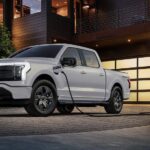 A white 2024 Ford F-150 Lightning is shown charging after visiting several Ford dealers.