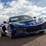 A blue 2025 Chevy Corvette ZR1 is shown driving to a Chevy dealer.