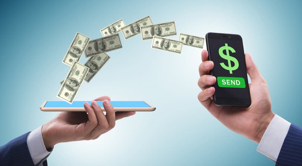 Money is shown being transferred between two cell phones.