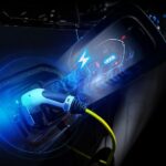 A close-up of the charge port is shown on an EV vehicle.