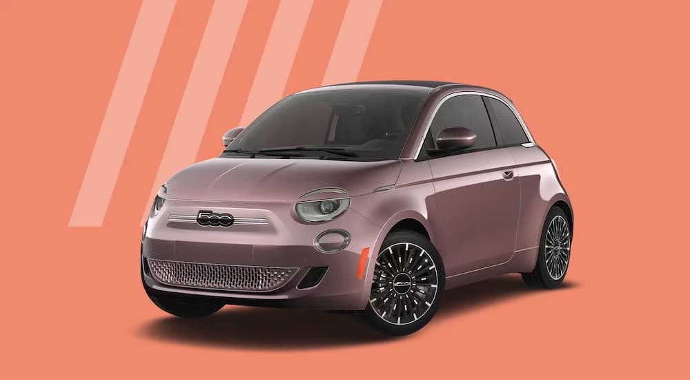 A pink 2024 FIAT 500e is shown parked with a simulated peach background..
