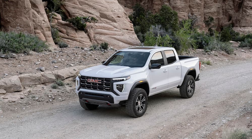 A white 2025 GMC Canyon AT4 off-road.