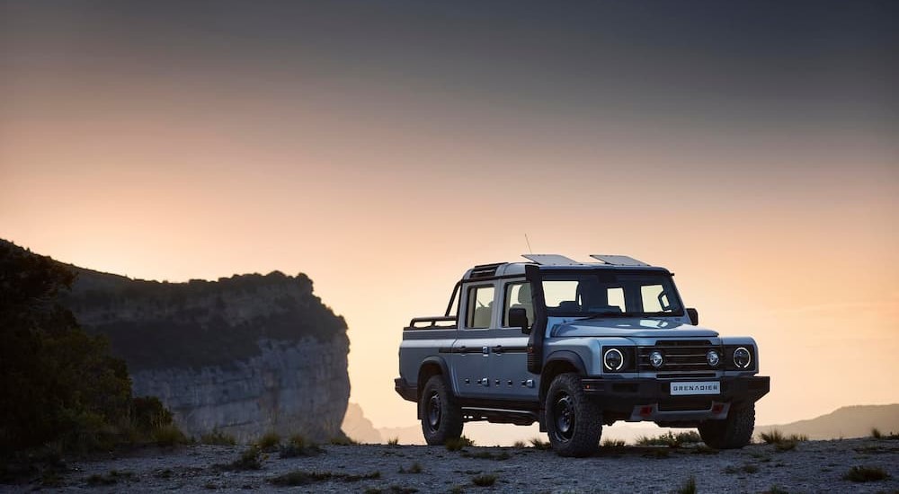 A silver INEOS Grenadier Station Wagon parked off-road.