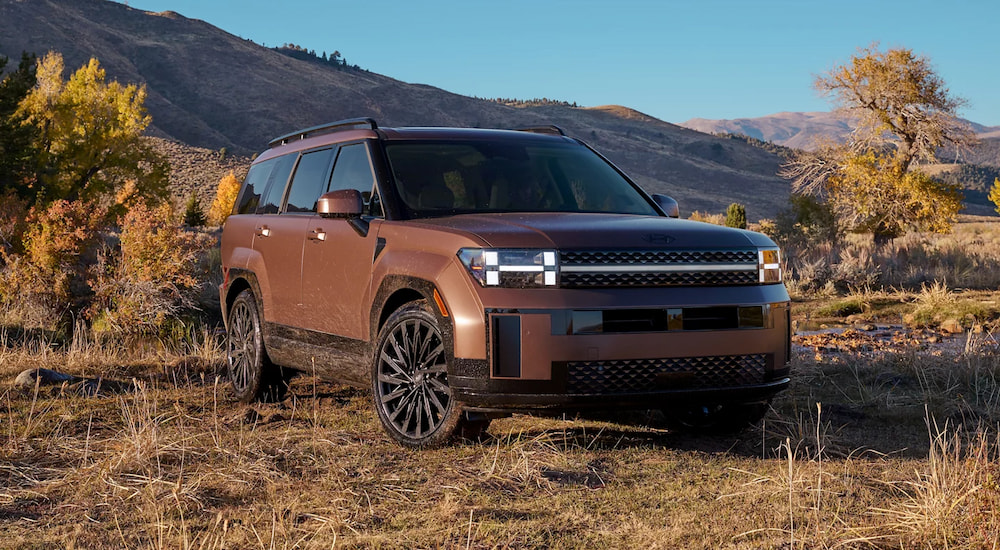 Brown 2025 Hyundai Santa Fe parked off-road.