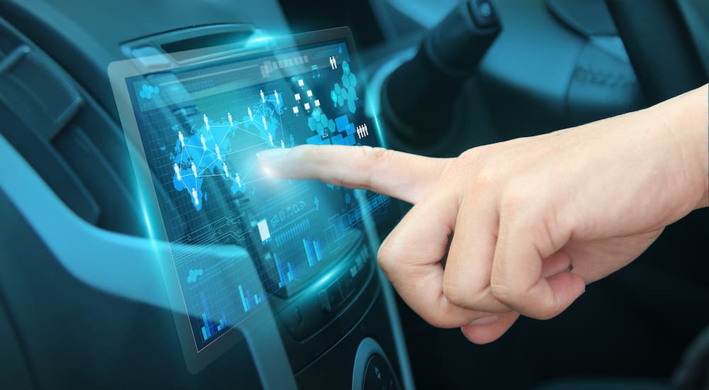 Index finger using touchscreen on a car infotainment display