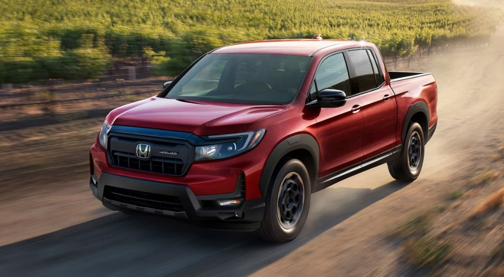 A red 2025 Honda Ridgeline from the front.